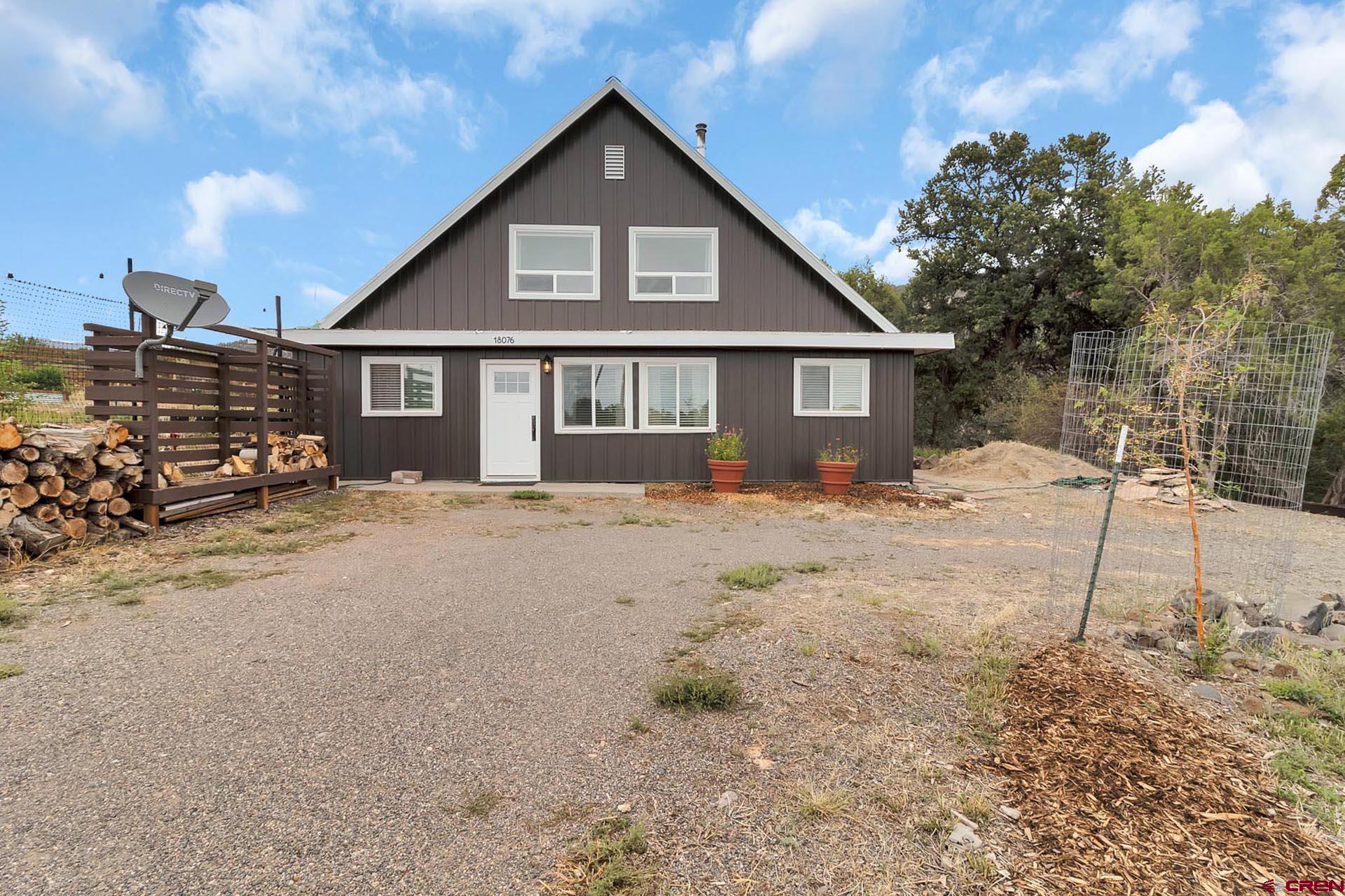 a front view of a house with a yard covered in snow