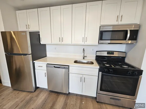 a kitchen with a stove microwave and refrigerator