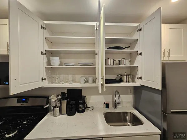 a kitchen that has a sink and a stove