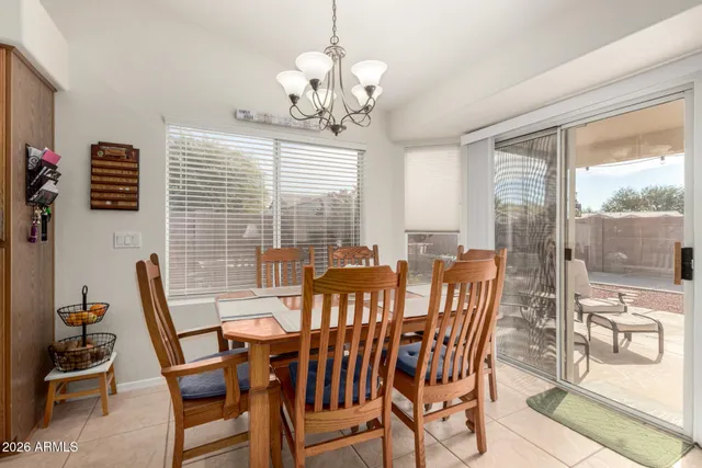 a view of a dining room with furniture wooden floor and a chandelier