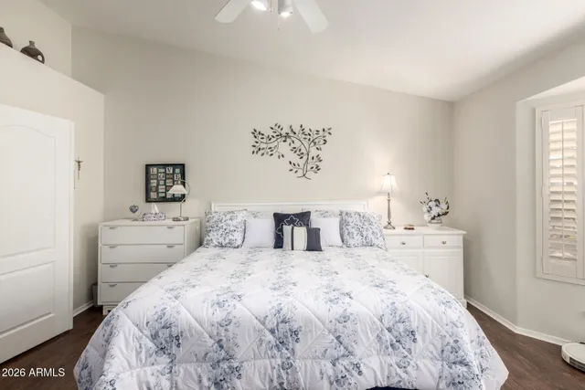 a bedroom with a bed and a window