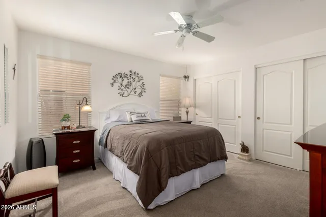 a spacious bedroom with a bed and a chandelier
