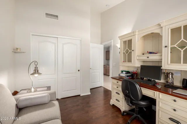 a view of a workspace with furniture and a window
