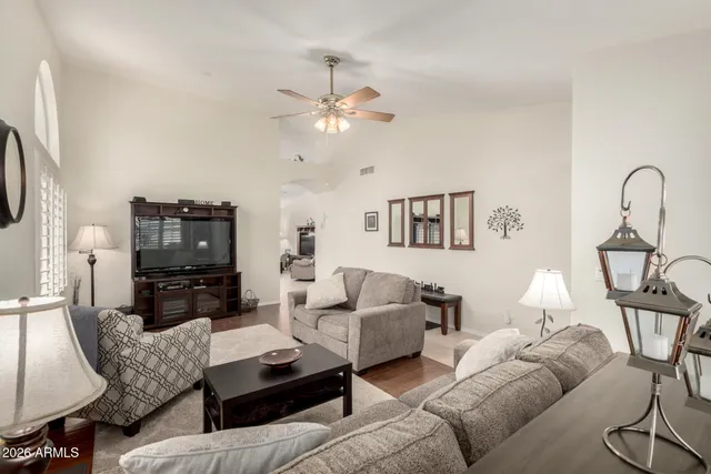 a living room with furniture a dining table and a fireplace