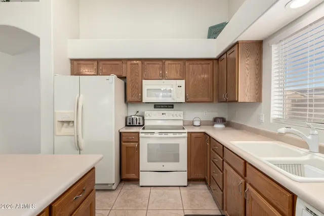 a kitchen with a sink a stove and refrigerator