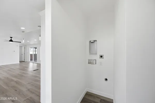 a view of a hallway with wooden floor