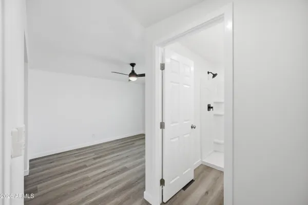 a view of a room with wooden floor