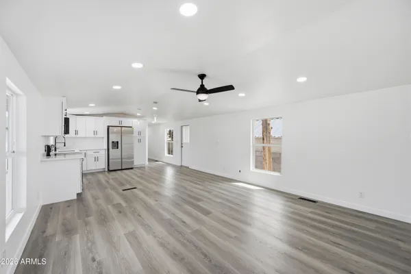 a view of a kitchen with a sink and wooden floor