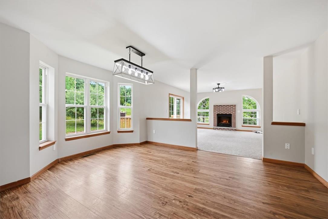 387 Blue Ridge Road Saylorsburg, PA 18353 - Photo 17 of 90 Natural light floods this inviting living space, highlighting the beautiful wood flooring and open-concept layout.