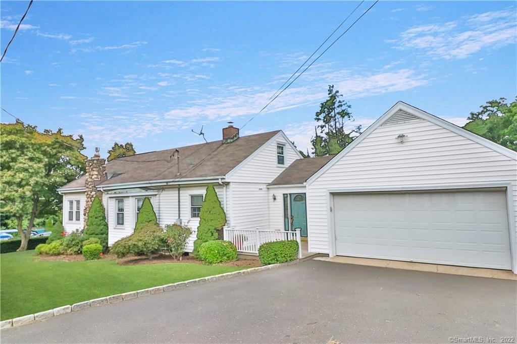 179 High Ridge Road Stamford, CT 06905 - Photo 1 of 1 a front view of a house with a yard and garage