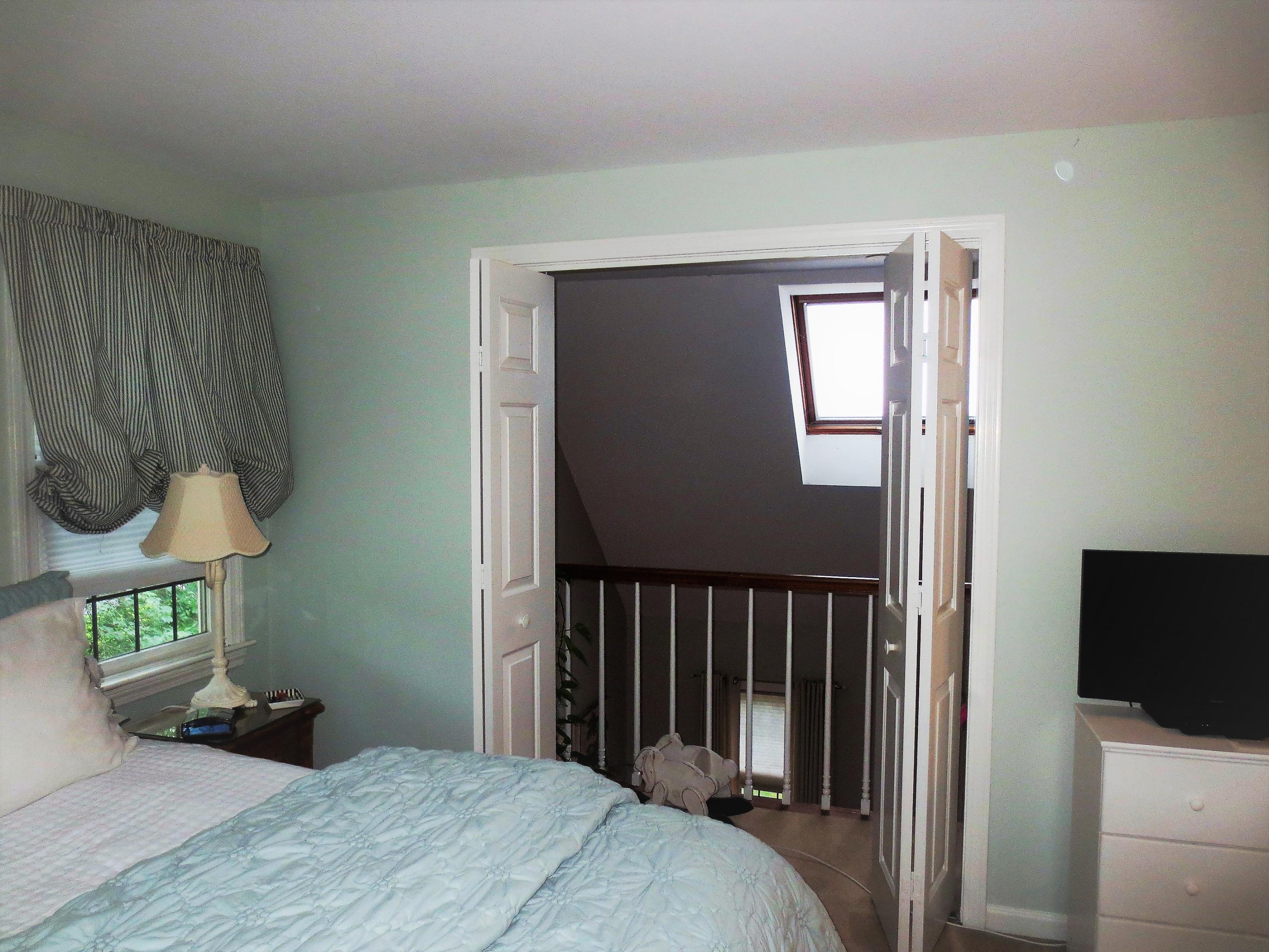 156 Braley Jenkins Road Centerville, MA 02632 - Photo 26 of 33 a bedroom with a bed and wooden floor