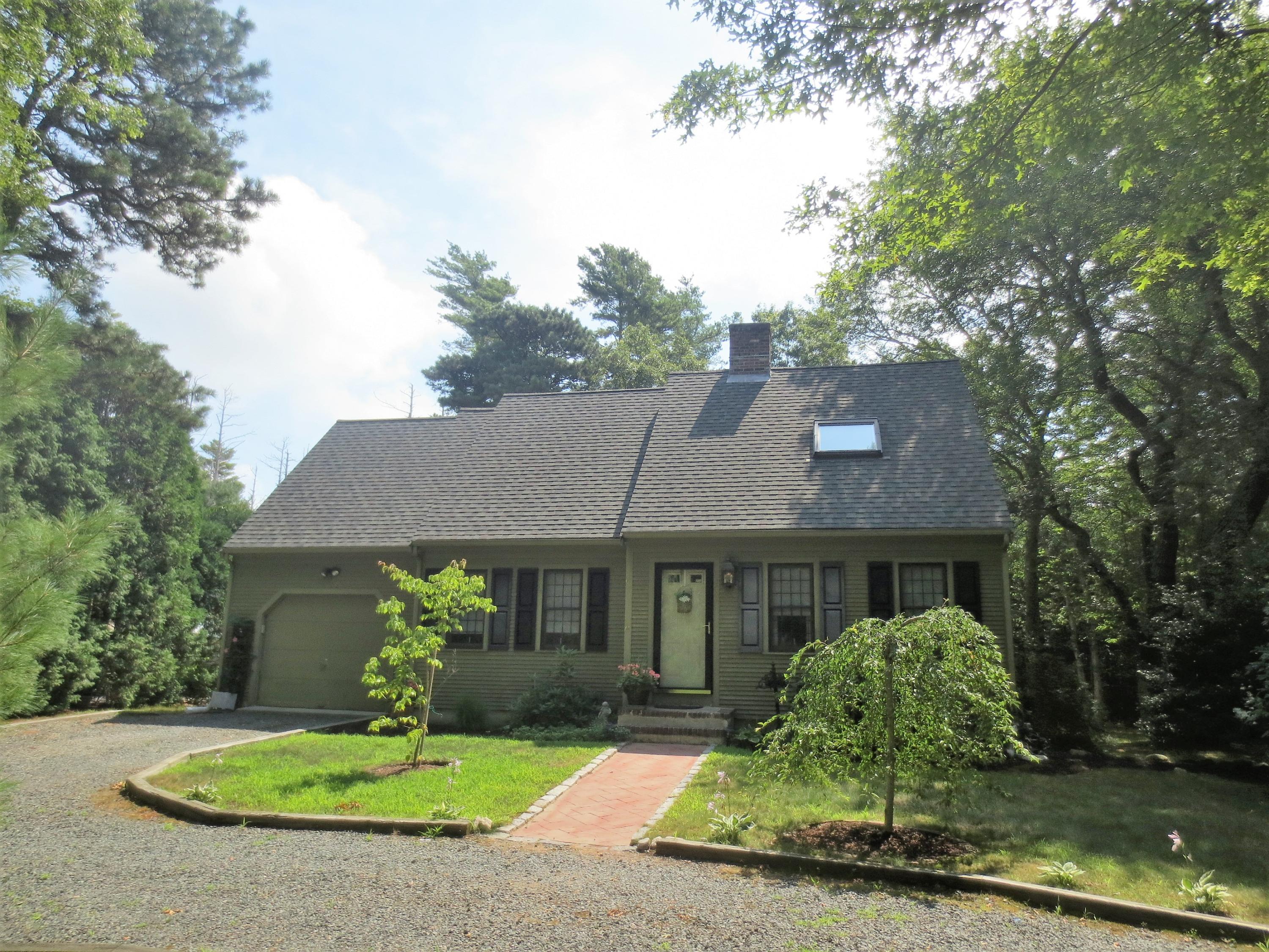 156 Braley Jenkins Road Centerville, MA 02632 - Photo 33 of 33 a front view of a house with a yard garage and outdoor seating