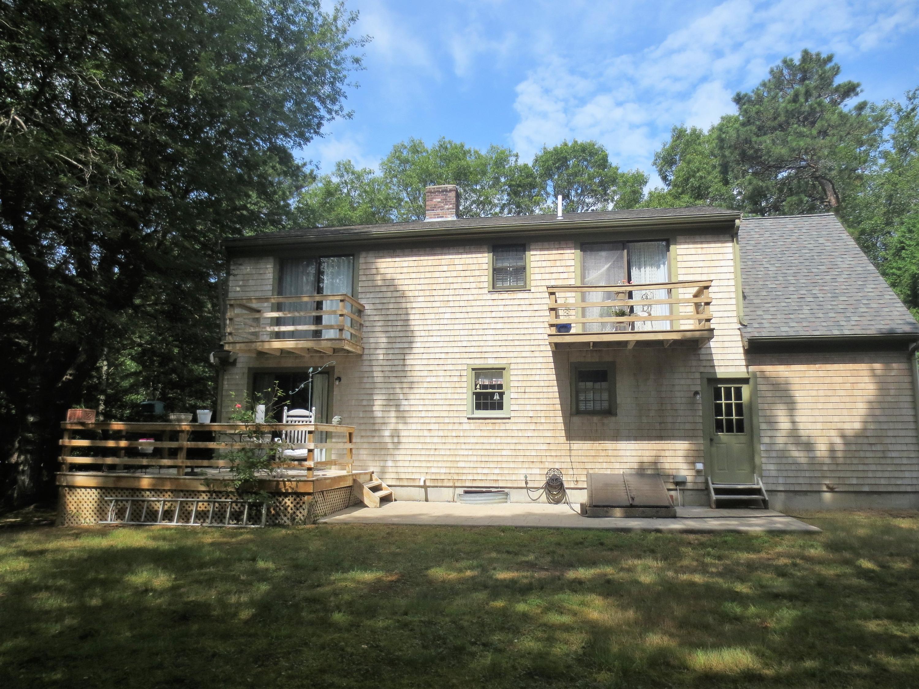 156 Braley Jenkins Road Centerville, MA 02632 - Photo 5 of 33 a front view of a house with a yard table and chairs