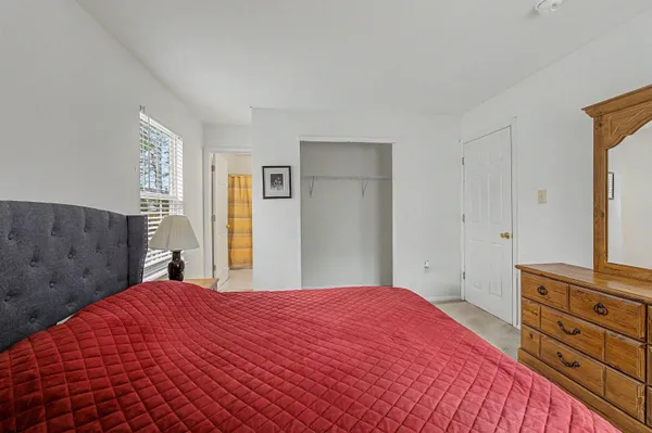a bedroom with a bed and a dresser