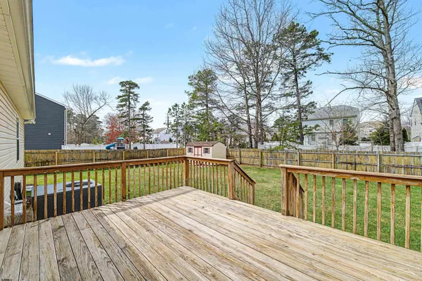 a view of balcony with wooden floor and fence