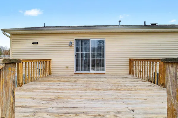 a view of a balcony with wooden floor and city view