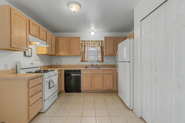 a kitchen with a white cabinets and white appliances