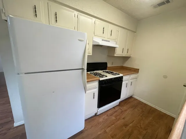 a white refrigerator freezer sitting inside of a kitchen