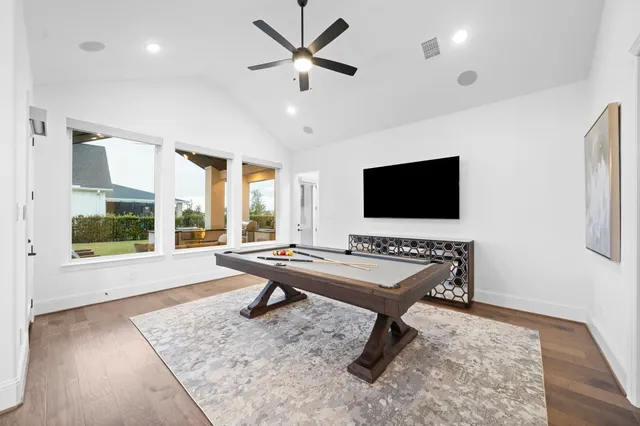 a living room with furniture flat screen tv and a large window