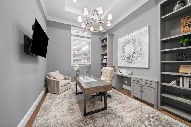 a living room with furniture a flat screen tv and kitchen view