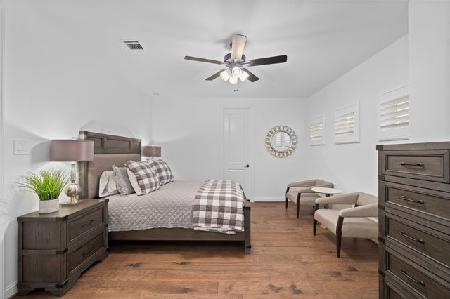 a bedroom with a bed and ceiling fan