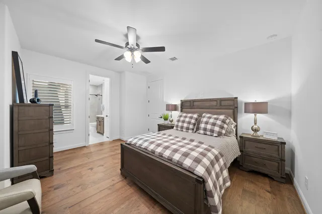 a bedroom with a bed and wooden floor
