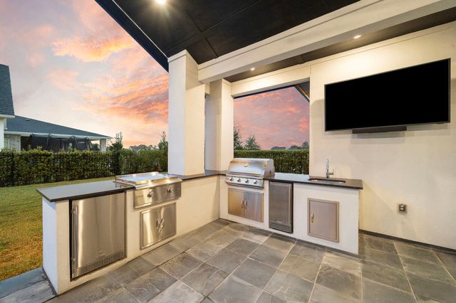 a kitchen with stainless steel appliances a stove a sink and a microwave