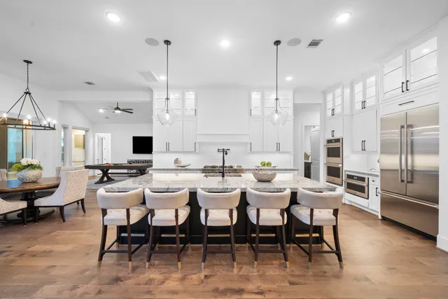 a large kitchen with a table and chairs