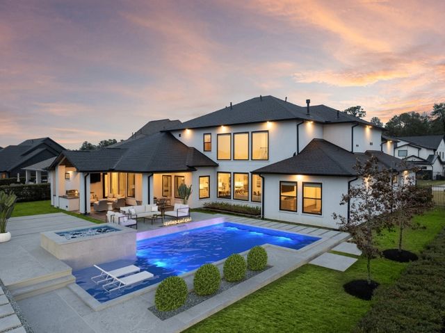 a front view of a house with yard and furniture