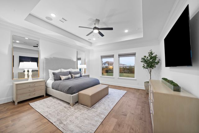 a spacious bedroom with a large bed and a flat screen tv