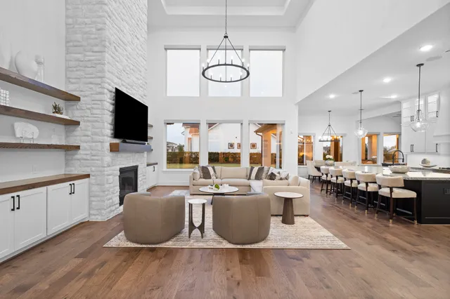 a large white kitchen with a large window and stainless steel appliances