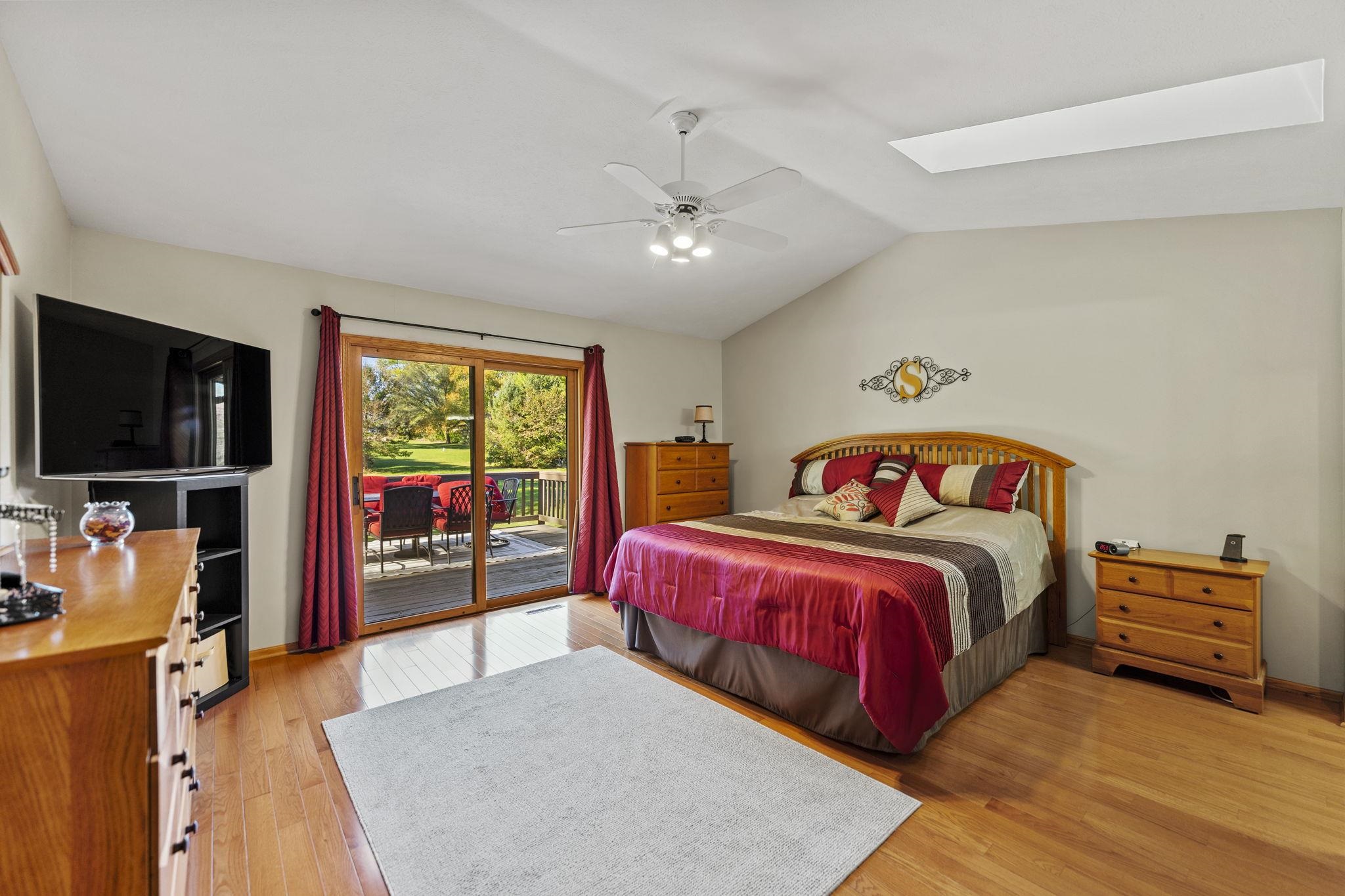 13546 Racoon Run Roscoe, IL 61073 - Photo 15 of 37 a bedroom with a bed and a flat screen tv
