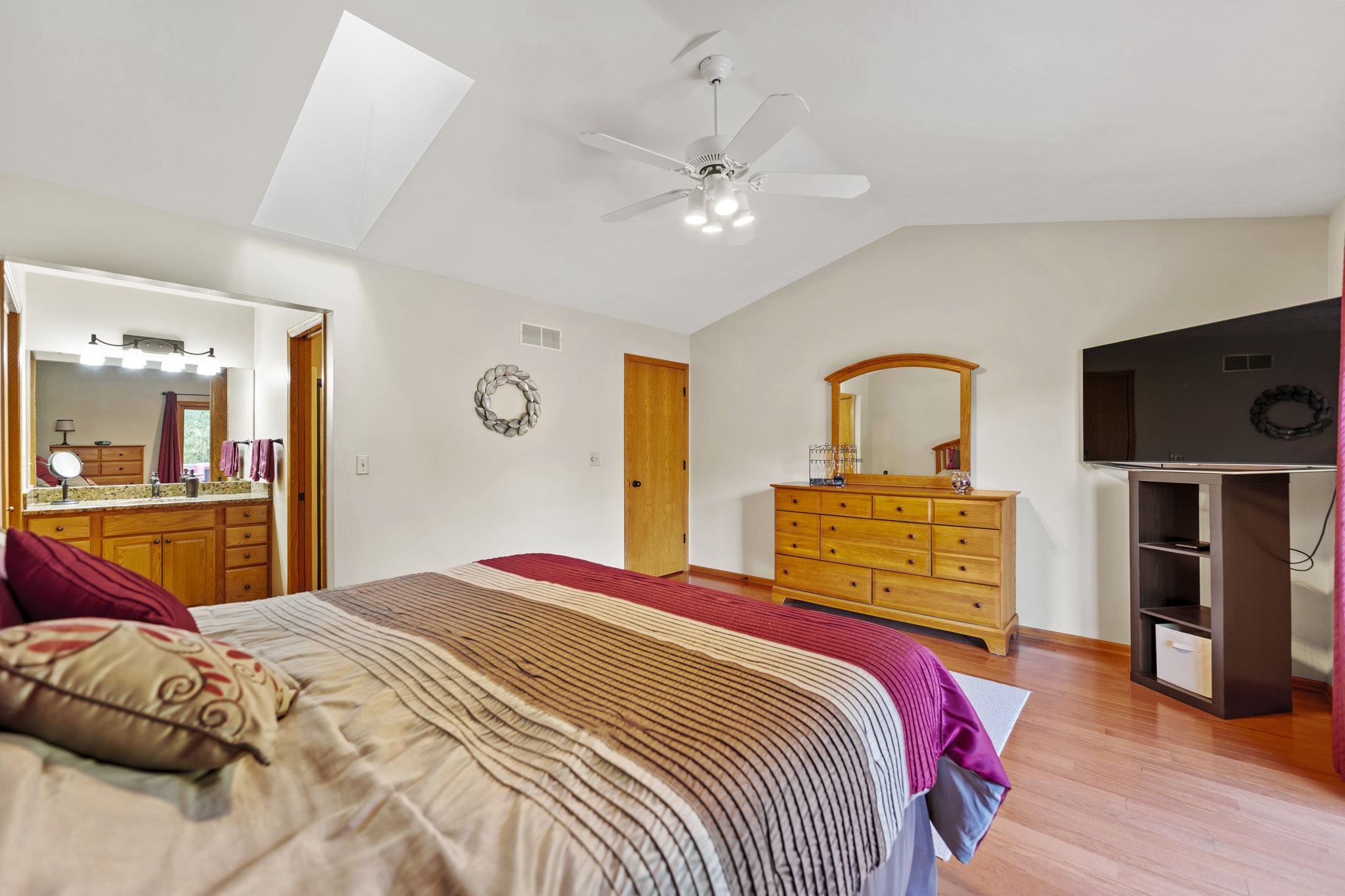 13546 Racoon Run Roscoe, IL 61073 - Photo 16 of 37 a bedroom with a large bed and flat screen tv