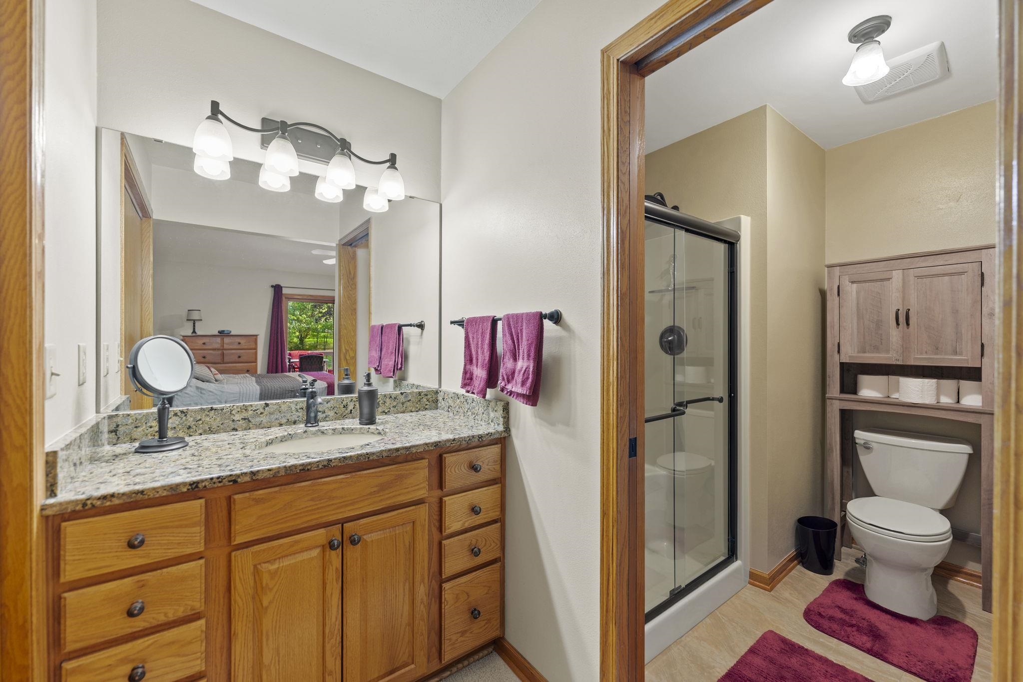 13546 Racoon Run Roscoe, IL 61073 - Photo 17 of 37 a bathroom with a toilet sink and mirror