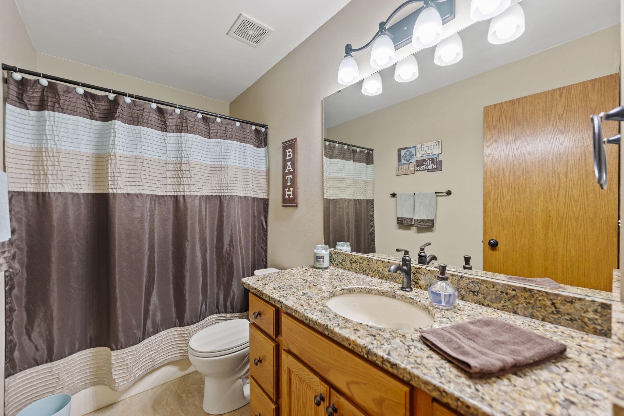 13546 Racoon Run Roscoe, IL 61073 - Photo 22 of 37 a bathroom with a granite countertop sink and a mirror