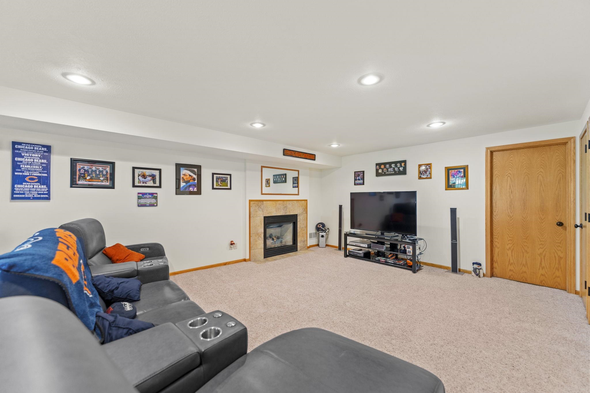 13546 Racoon Run Roscoe, IL 61073 - Photo 24 of 37 a living room with furniture flat screen tv and a fireplace