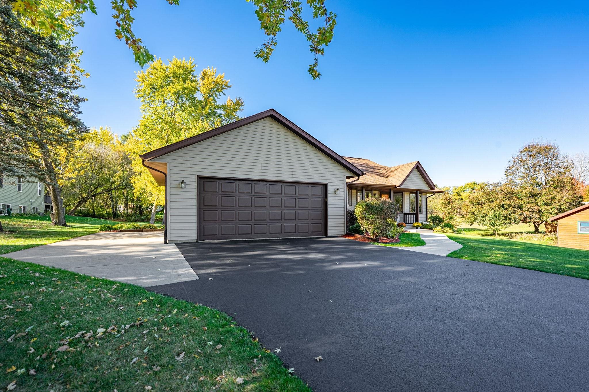 13546 Racoon Run Roscoe, IL 61073 - Photo 4 of 37 a front view of a house with a yard and garage