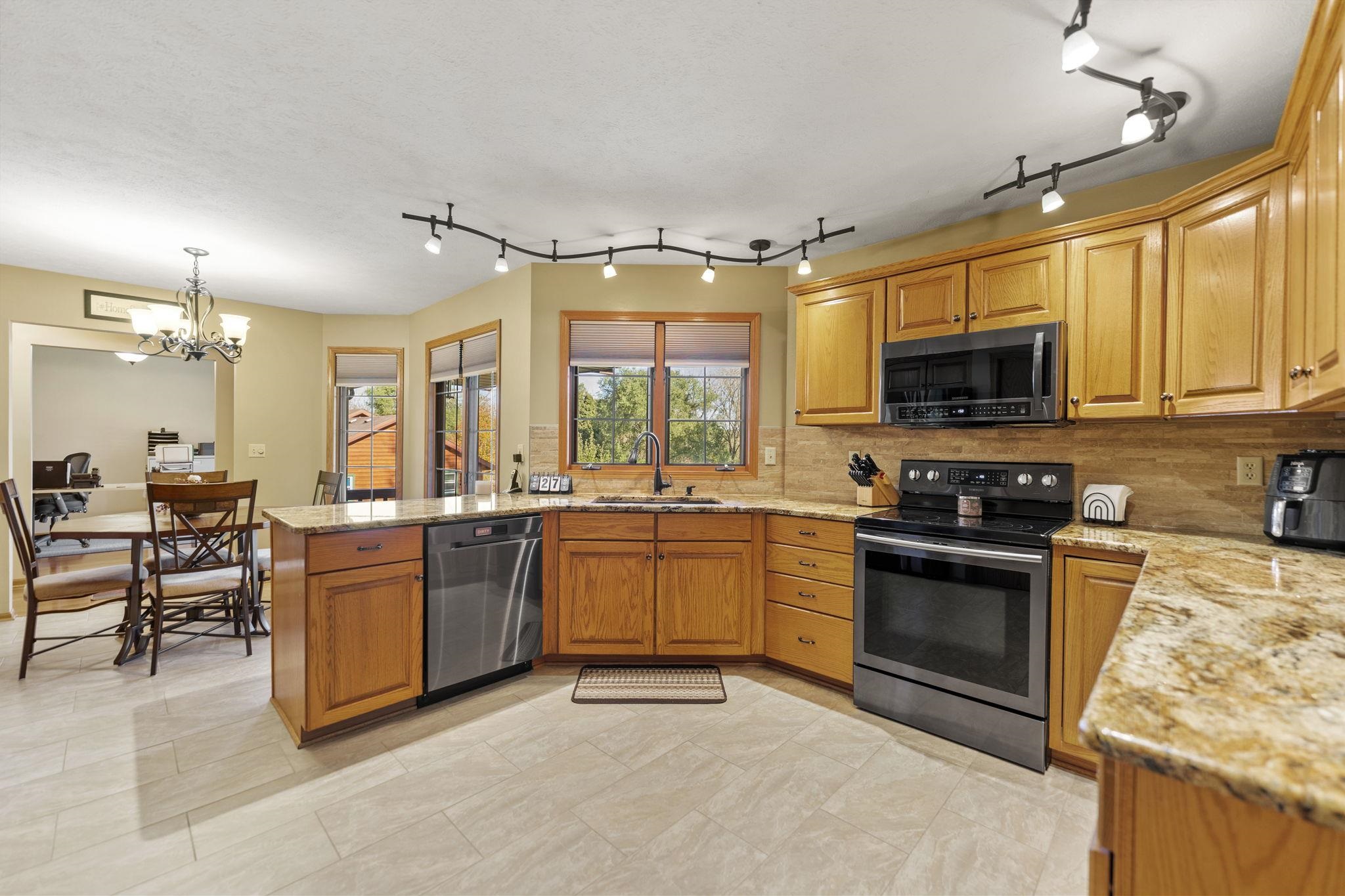 13546 Racoon Run Roscoe, IL 61073 - Photo 8 of 37 a kitchen with lots of counter top space appliances and a sink