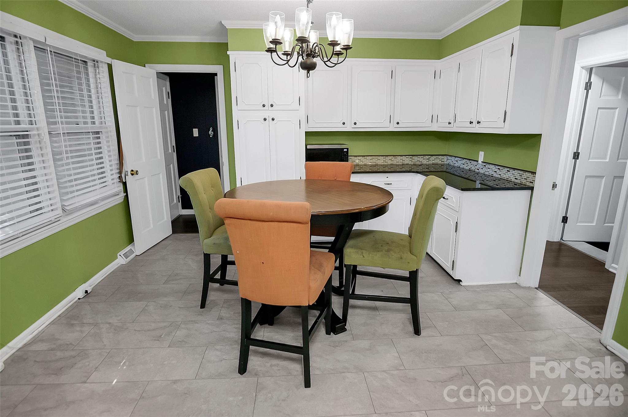 808 Old Mt Holly Road Stanley, NC 28164 - Photo 28 of 48 a view of a dining room with furniture and a chandelier
