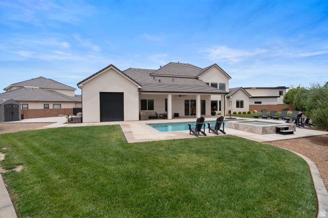 2278 Tawny Ridge Circle St. George, UT 84790 - Photo 61 of 61 Expansive rear yard featuring a rectangular swimming pool, integrated spa, and a concrete patio surround.