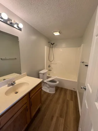 a bathroom with a sink a toilet a shower and a mirror