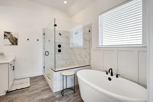 a bathroom with a bathtub shower sink and toilet