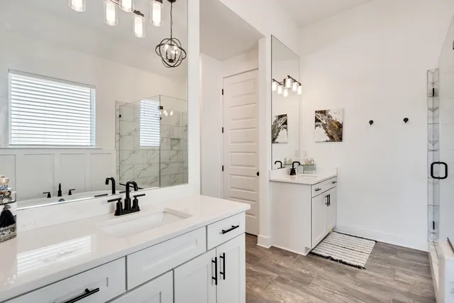 a white bath tub sitting next to a white sink and a shower