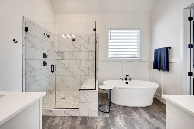 a bathroom with a sink vanity granite tub and shower