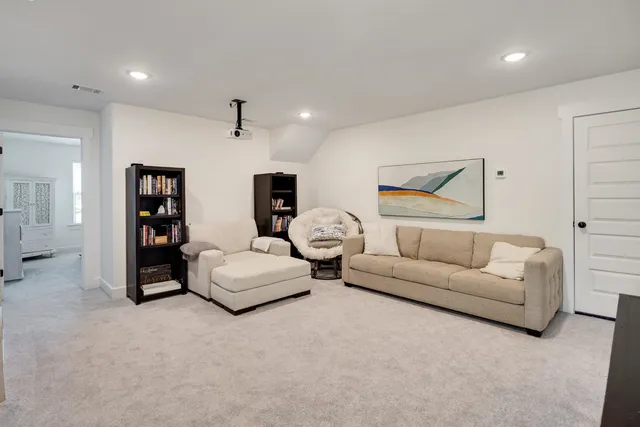 a view of a hallway with wooden floor and entryway