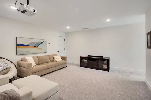 a living room with furniture and white walls