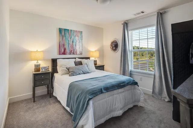 a bedroom with a bed and a view of closet