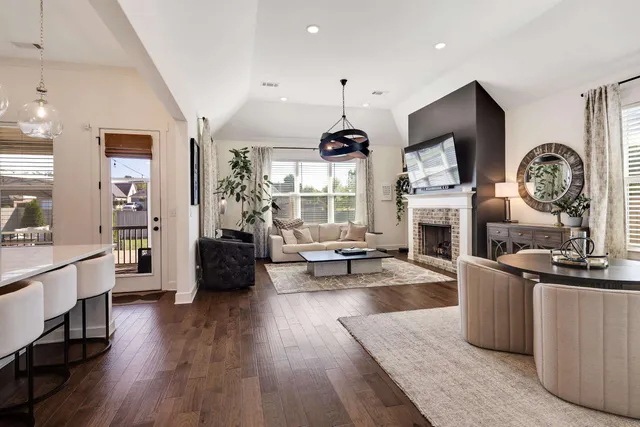 a living room with fireplace furniture and a flat screen tv