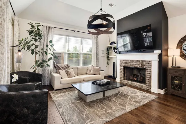 a living room with furniture fireplace and flat screen tv