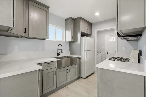 a kitchen with stainless steel appliances a refrigerator sink and cabinets